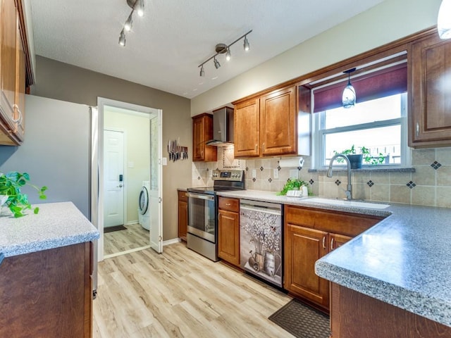 kitchen with electric stove, dishwashing machine, wall chimney exhaust hood, light wood-style floors, and a sink