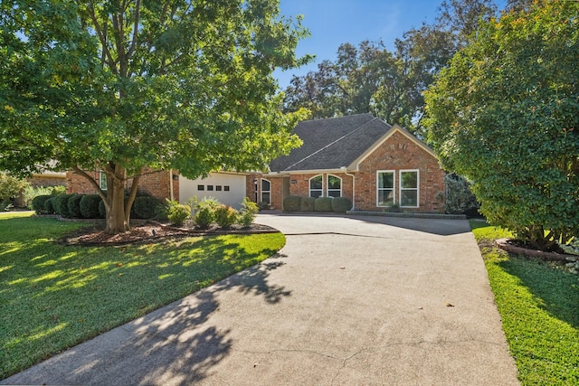 view of front of property featuring driveway, a garage, a front yard, and brick siding