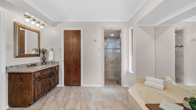 bathroom featuring crown molding, a stall shower, vanity, baseboards, and a bath