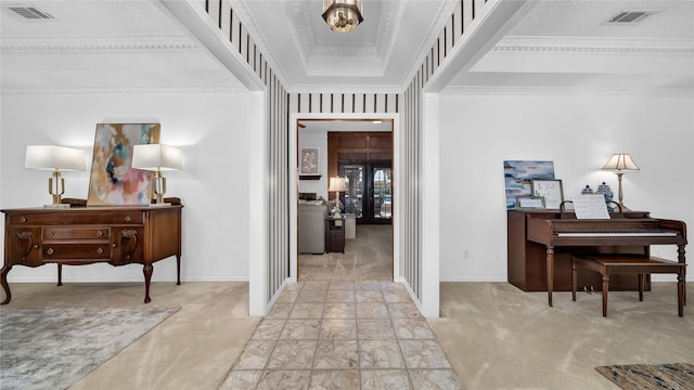 interior space with baseboards, carpet, visible vents, and crown molding