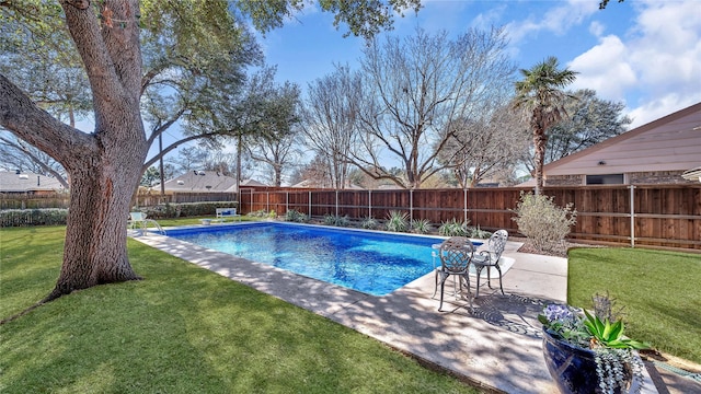 view of swimming pool featuring a patio area, a fenced backyard, a fenced in pool, and a lawn