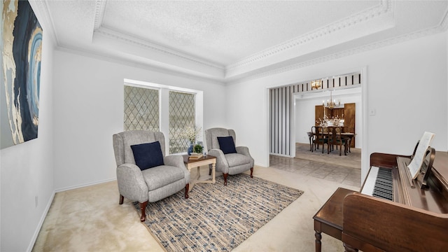 living area featuring a textured ceiling, a tray ceiling, ornamental molding, and a notable chandelier