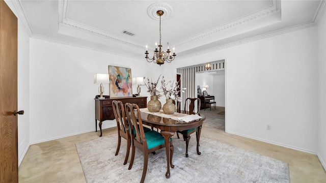 dining room with visible vents, a tray ceiling, a chandelier, and ornamental molding