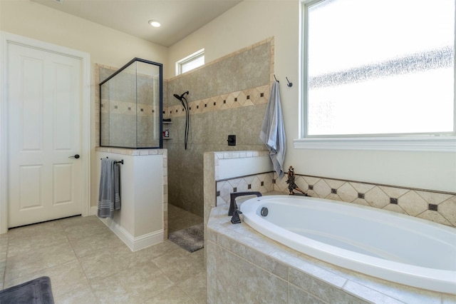 full bathroom featuring a garden tub, a walk in shower, and tile patterned floors