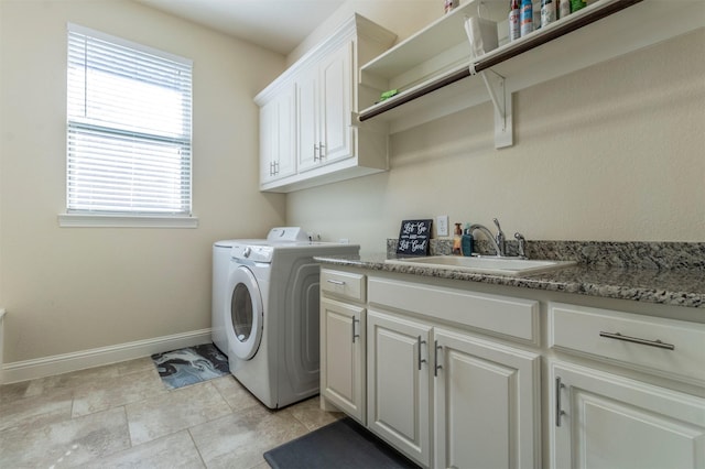 washroom featuring cabinet space, baseboards, and a sink