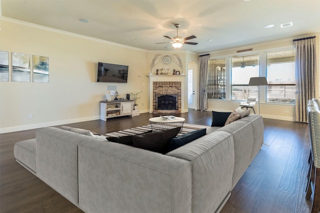 living area with visible vents, baseboards, ornamental molding, a brick fireplace, and dark wood finished floors