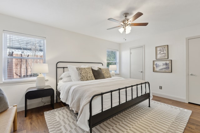 bedroom featuring a ceiling fan, baseboards, and wood finished floors