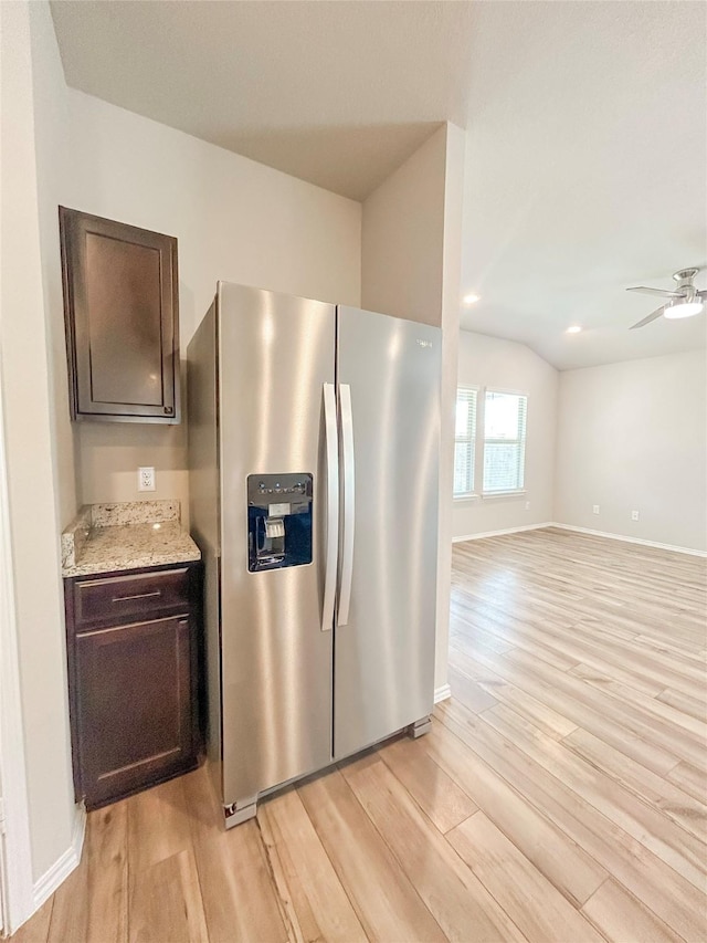 kitchen with light wood-type flooring, dark brown cabinets, and stainless steel refrigerator with ice dispenser