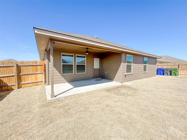 rear view of property featuring a patio area, ceiling fan, and fence