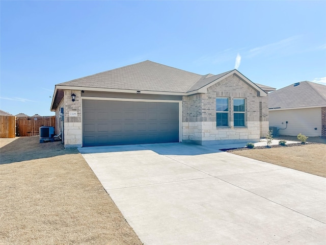 single story home featuring an attached garage, central AC, fence, concrete driveway, and stone siding