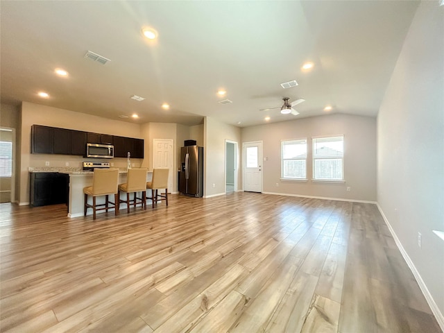 living room with light wood-style floors, recessed lighting, and visible vents