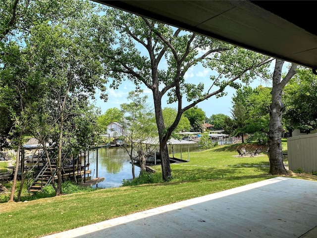 exterior space featuring a yard and a water view