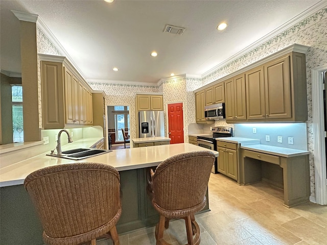 kitchen with stainless steel appliances, a sink, visible vents, wallpapered walls, and crown molding