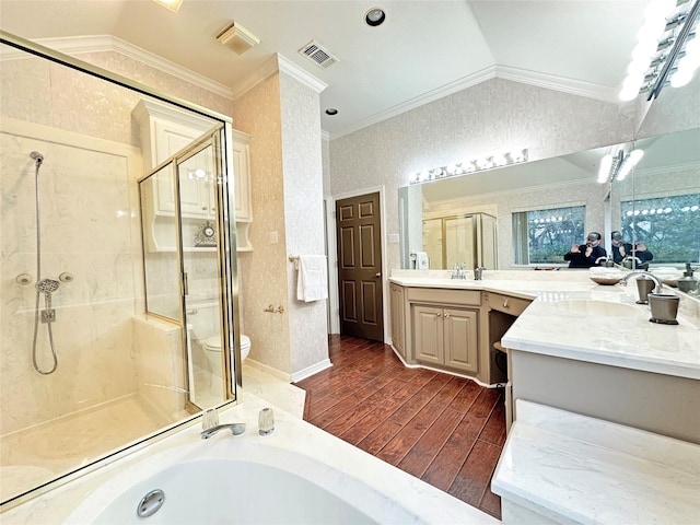 full bathroom with lofted ceiling, visible vents, ornamental molding, a shower stall, and wood finished floors