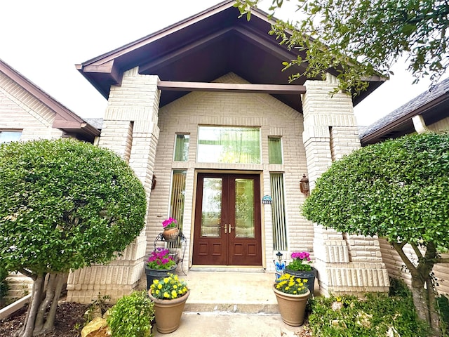 doorway to property with french doors and brick siding