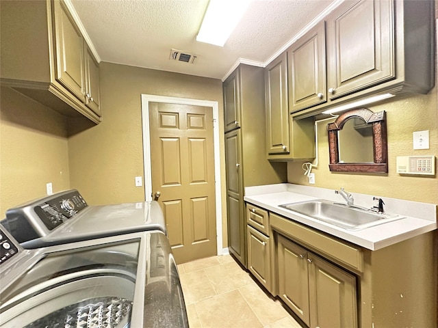 laundry area featuring cabinet space, visible vents, a sink, a textured ceiling, and separate washer and dryer