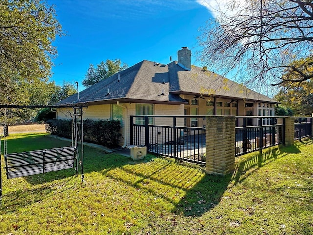 back of house with a patio area, a yard, a chimney, and fence