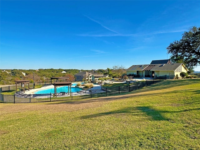 surrounding community featuring a pool, a lawn, and fence