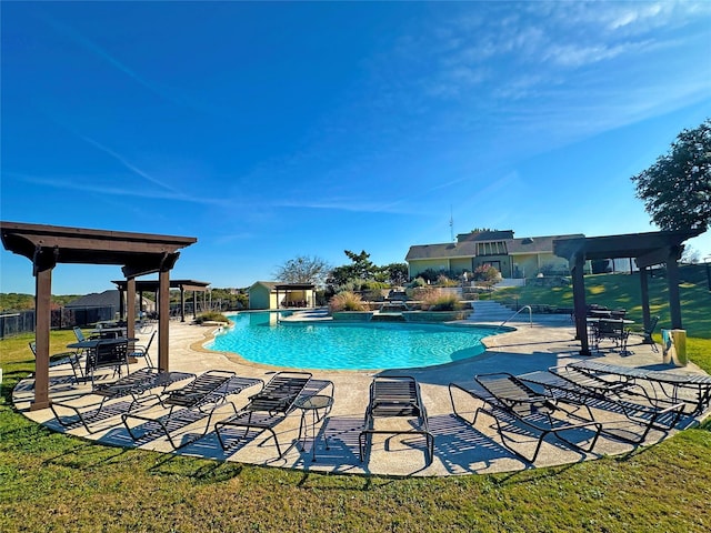 pool featuring a yard, a patio area, and fence