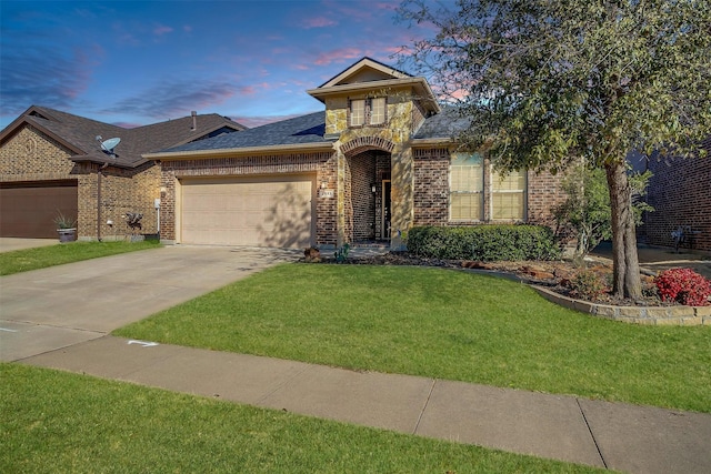 view of front of house featuring concrete driveway, a front yard, a shingled roof, a garage, and brick siding