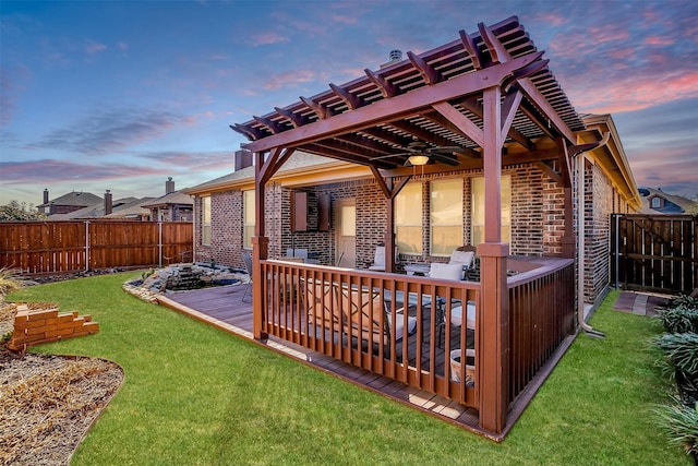 exterior space with ceiling fan, a fenced backyard, a pergola, and a lawn