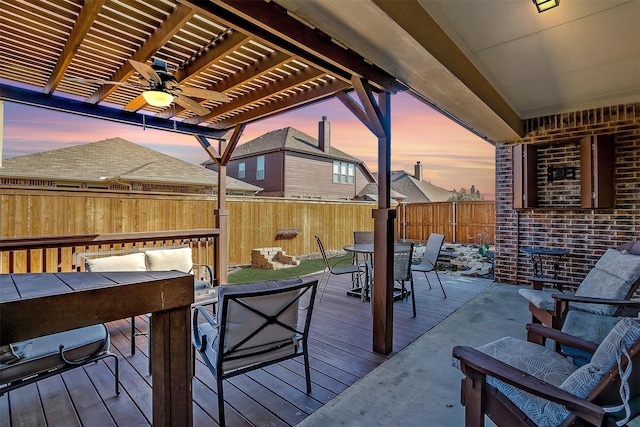 deck featuring outdoor dining area, fence, a pergola, and ceiling fan