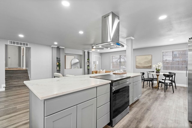 9723 Queenswood Ln, Dallas, TX 75238 - kitchen featuring a center island, visible vents, recessed lighting, range hood, and appliances with stainless steel finishes