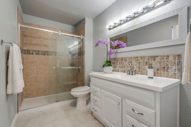 9723 Queenswood Ln, Dallas, TX 75238 - full bath featuring tile patterned flooring, backsplash, toilet, vanity, and a stall shower