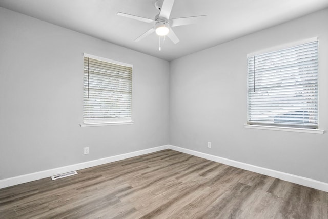 9723 Queenswood Ln, Dallas, TX 75238 - empty room with ceiling fan, baseboards, wood finished floors, and visible vents
