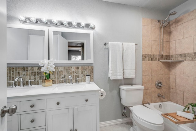 9723 Queenswood Ln, Dallas, TX 75238 - bathroom featuring tasteful backsplash, toilet, baseboards, shower / bath combination, and vanity