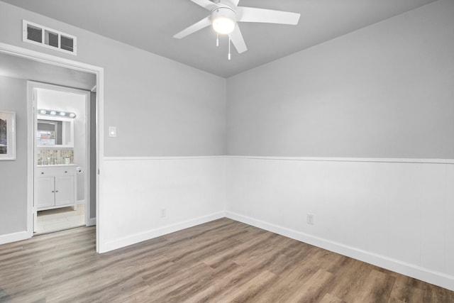 9723 Queenswood Ln, Dallas, TX 75238 - spare room featuring wood finished floors, baseboards, a ceiling fan, and visible vents