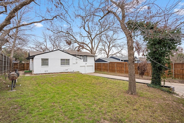 9723 Queenswood Ln, Dallas, TX 75238 - rear view of property featuring concrete driveway, an attached garage, a fenced backyard, and a lawn
