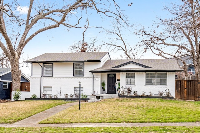 9723 Queenswood Ln, Dallas, TX 75238 - split level home with brick siding, a front lawn, and fence