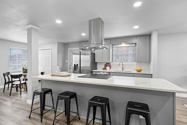 9723 Queenswood Ln, Dallas, TX 75238 - kitchen featuring island range hood, gray cabinets, a sink, black electric stovetop, and stainless steel refrigerator with ice dispenser