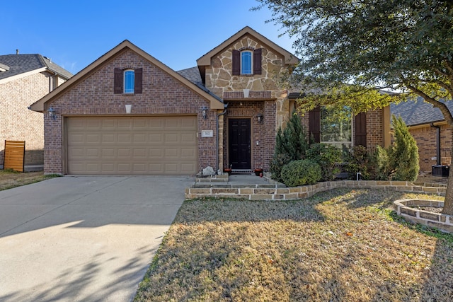 view of front of property with a garage, concrete driveway, brick siding, and stone siding