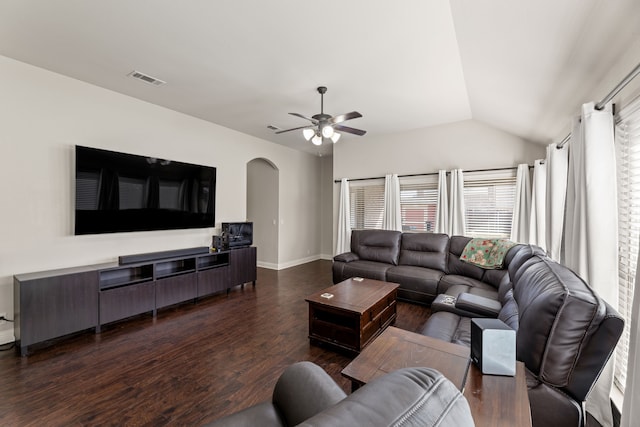 living room with lofted ceiling, arched walkways, dark wood-style flooring, visible vents, and a ceiling fan