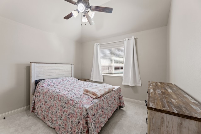 carpeted bedroom with a ceiling fan, lofted ceiling, and baseboards