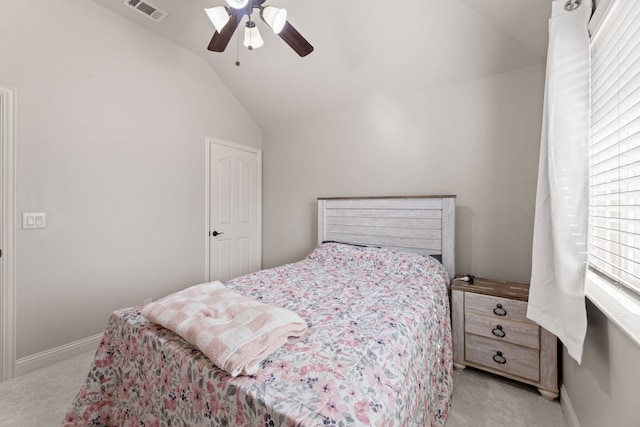 bedroom featuring light carpet, baseboards, visible vents, a ceiling fan, and vaulted ceiling