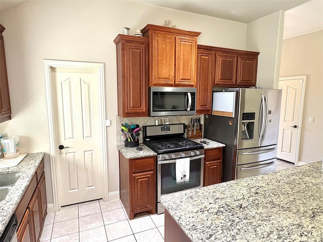 312 Salisbury Dr, Anna, TX 75409 - kitchen with stainless steel appliances, light tile patterned flooring, tasteful backsplash, and light stone counters