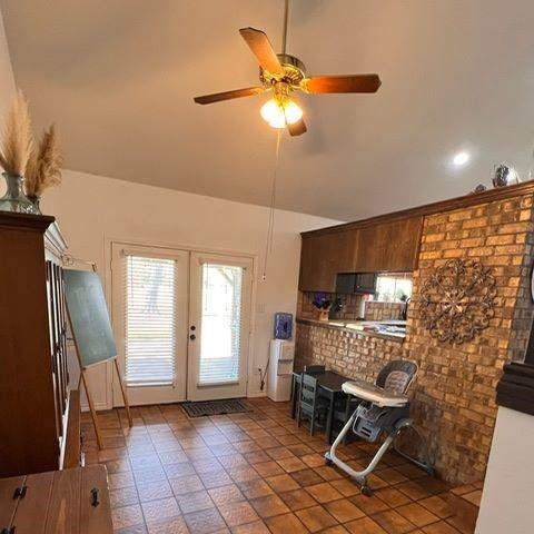 kitchen featuring a ceiling fan, lofted ceiling, and french doors