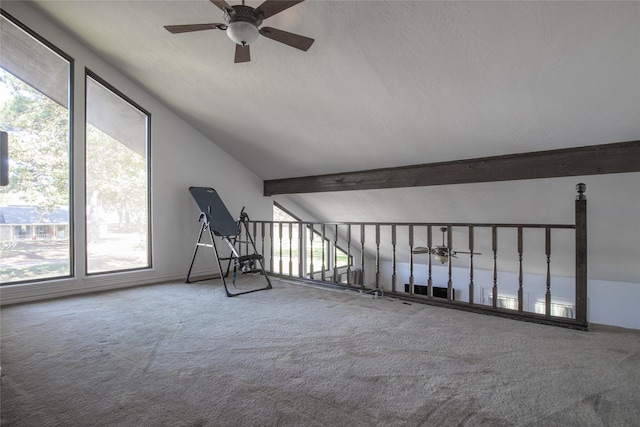 interior space featuring lofted ceiling with beams, a textured ceiling, carpet flooring, and a ceiling fan