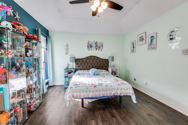 bedroom with a ceiling fan, a textured ceiling, baseboards, and wood finished floors