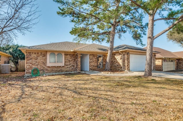 single story home featuring concrete driveway, an attached garage, fence, cooling unit, and brick siding