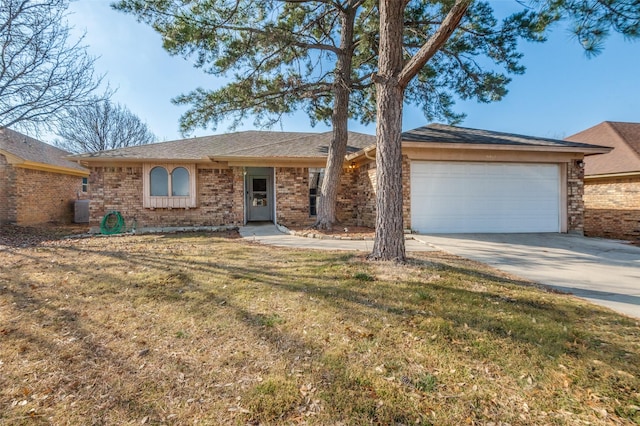 ranch-style home featuring central AC unit, a garage, brick siding, concrete driveway, and a front lawn