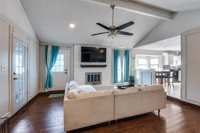 living area with vaulted ceiling with beams, dark wood-style floors, and a healthy amount of sunlight