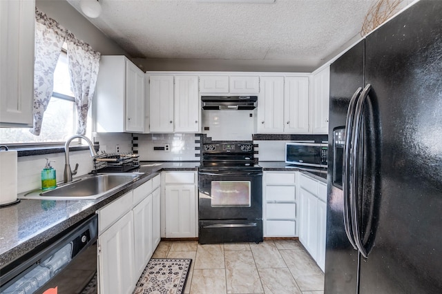 kitchen with tasteful backsplash, white cabinets, under cabinet range hood, black appliances, and a sink