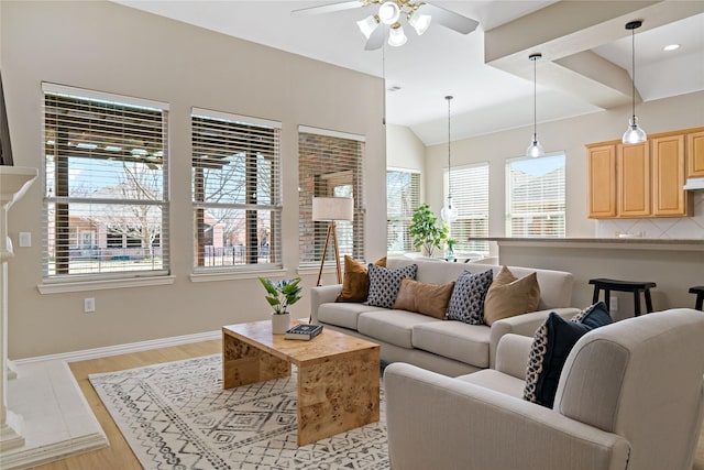 living area featuring lofted ceiling, ceiling fan, light wood-style flooring, and baseboards