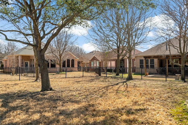 back of house featuring fence and brick siding