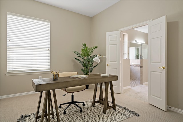 office featuring light carpet and baseboards