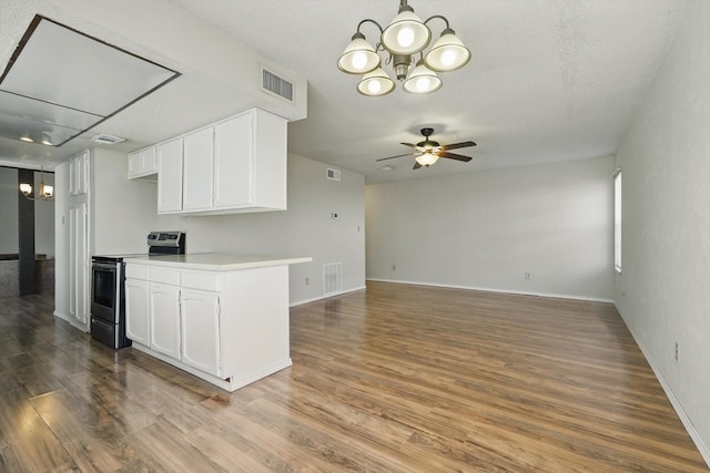 kitchen featuring electric stove, visible vents, and white cabinets